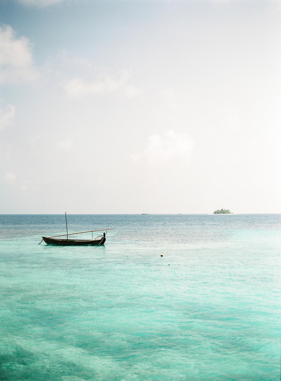 maldives boat on the water and desert island